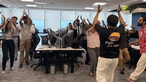 group of people dancing together with hands raised