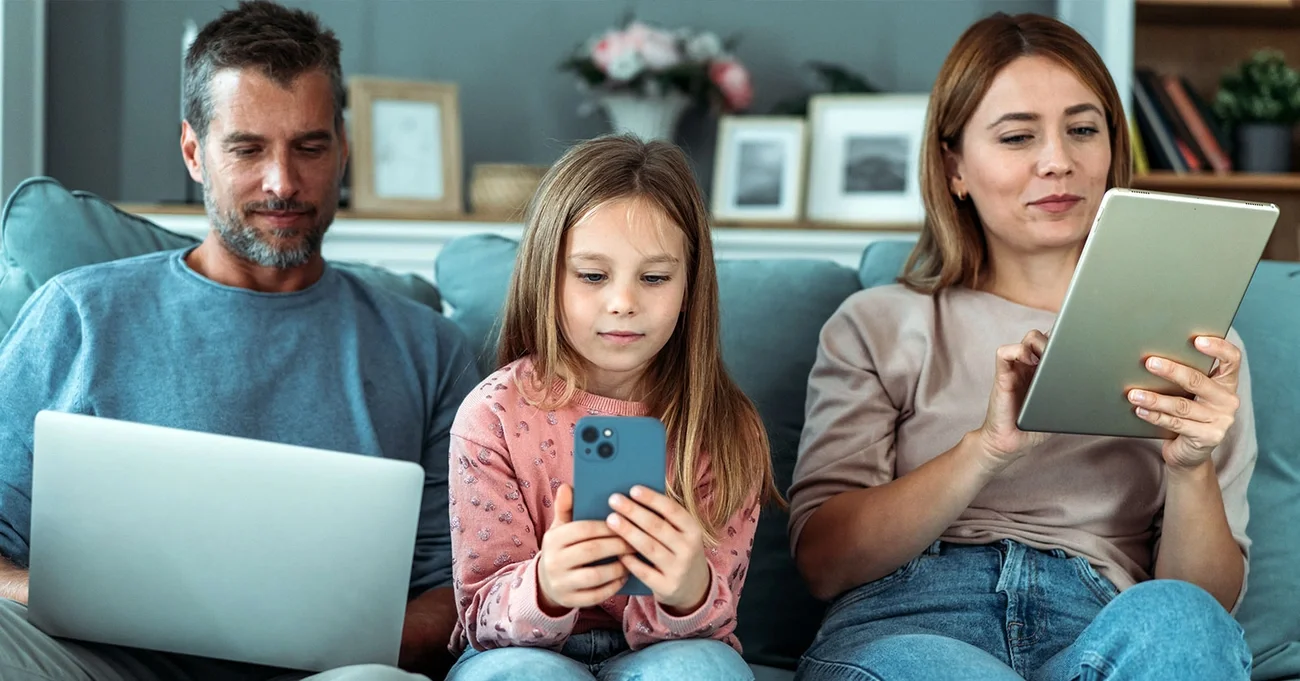 parents and daughter using digital devices