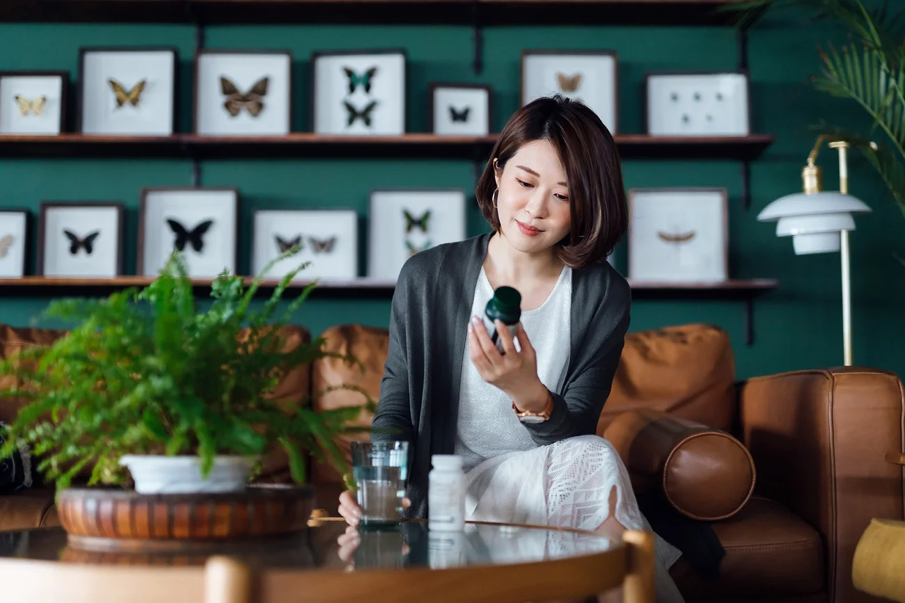 Woman looking at medication bottle