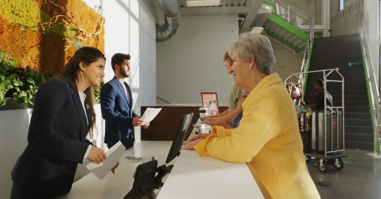 people at reception desk 